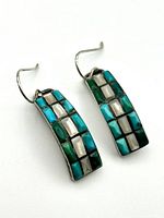 Front view of Navajo sterling silver earrings showing rectangular multicolor inlay with turquoise, green, mother of pearl, and black stones.