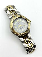 Photo of the watch showing face, bezel, and bracelet with lighting reflecting off the metallic surfaces