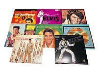 Photo showing front covers of 8 Elvis Presley record albums laid out flat on a white surface.