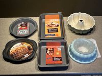 Top-down view of all baking pans and jello molds showing labels and condition.