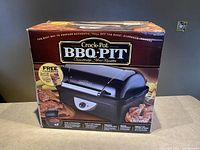 Front view of Crock-Pot BBQ Pit box showing branding and product image.