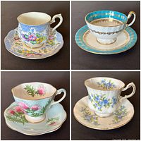 Four vintage teacup and saucer sets shown from above, each displaying delicate floral designs and gold accents.
