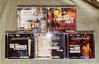 Photo of the front covers of five Agatha Christie BBC Audio book CDs showing titles and artwork for Sad Cypress, Hallowe'en Party, The Murder of Roger Ackroyd, One, Two, Buckle My Shoe, and The ABC Murders.