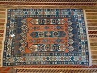 Full view of rug laid flat on floor showing overall pattern and edges