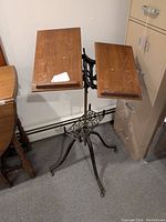 Front view showing dual oak wood panels on cast iron frame, angled upwards with a lip to hold books open.