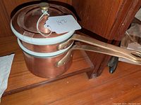 Complete set of copper and porcelain double boiler with lid and handle.