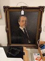 Full view of the oil painting portrait of distinguished gentleman in an ornate carved frame.