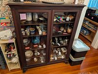 Wide front shot of mahogany bookcase showing two locking glass doors, carved molding and base