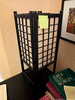 Japanese style floor lamp with black wood frame and rice paper panels in daylight showing condition and materials