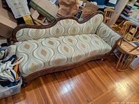 Full front left view showing overall shape, frame and upholstery