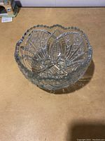 Top view showing the detailed cut glass patterns and scalloped edge of the bowl.