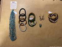 Photo showing the full collection: multi-strand turquoise necklace, six beaded bracelets in multiple colors, a pair of earrings, and a turquoise ring