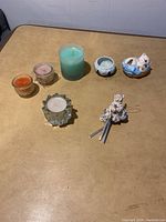 View of all items on table, showing candles and ceramic nicknacks