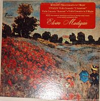 Cover of Elvira Madigan soundtrack vinyl record featuring Mozart Piano Concerto, Vivaldi Violin Concertos with impressionist style landscape background and red label detailing tracks.
