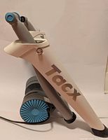 Side view of Tacx cycling trainer frame showing white and gray color with Tacx branding.