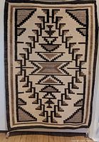 Full view of Navajo rug showing geometric pattern and colors