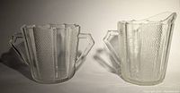 Photo showing side-by-side creamer and sugar bowl with hexagonal handles and Dewdrop pattern texture.