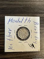 Reverse side of 1902 Canadian silver 5 cent coin mounted in paper holder, handwritten notes visible around the coin.