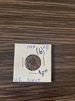 Front view of 1919 Lincoln one cent coin housed in cardboard flip with marking '1919 VF (6)' and price $8.00.