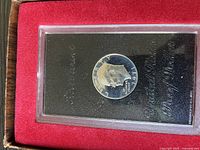 1971 Eisenhower Silver Dollar Peg Leg Error Coin in protective casing showing reflective proof finish and coin details.