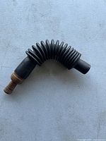 Image of the full goose call showing the flexible rubber ribbed horn and wooden mouthpiece