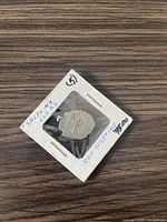 Ancient silver coin in holder showing the reverse with structure and inscription 'DAE SEGETIAE'