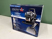 Original retail box of Bissell Little Green HydroSteam Pet steam cleaner showing front with product image and features.