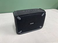 Front view of the black iHome Weather Tough Bluetooth speaker showing the protective rubber edges and front metal grille with the 'iHome' logo.