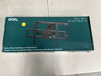 Box of onn. Extra-Wide Full Motion TV Wall Mount showing product image and dimensions 50 in - 86 in (127 cm - 218.44 cm). New in box.