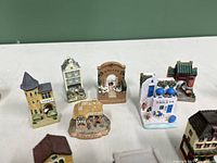 Close-up photo of 6 miniature ceramic buildings showing intricate details and Baileys signage.