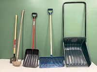 Front view of all five items standing upright against green wall showing all tools in lot.