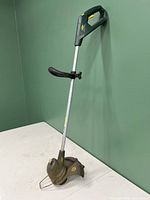 Full view of Yardworks edge trimmer showing handle, shaft, and trimming head with cutting guard and support wire ring.
