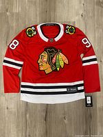 Front view of red Chicago Blackhawks breakaway jersey with Connor Bedard number 98 and Blackhawks logo.