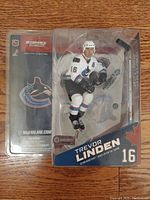Front view of McFarlane Sports Picks NHL 8 Trevor Linden figure in packaging showing player posed, wearing Vancouver Canucks white jersey with number 16.
