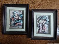 Both vintage Hummel styled shadow box art pieces together on floor, showing size and framing.