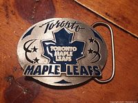 Front view of the vintage Toronto Maple Leafs pewter belt buckle with detailed enamel highlighting on the maple leaf and text.