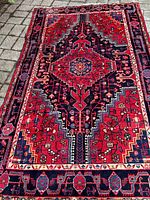 Full view of rug laid out on outdoor surface