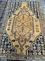 Full view of rectangular rug laid on paving