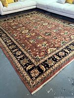 Full view of rectangular rug laid out in living room setting with light sofa.
