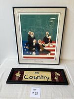Framed print showing Founding Fathers and American flag elements, alongside the wood framed embroidered plaque stating My Country on a shelf.