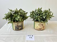 Two decorative painted planters with removable faux plants, showing front and side views