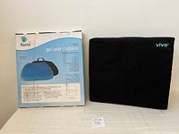 Photo of Fomi gel seat cushion box with blue gel cushion image and black Vive memory foam cushion with cover on table