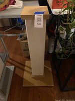 Front view of the SmartCat Ultimate Scratching Post showing the cardboard scratching surface, wooden base, and top platform with a MaxSold label.