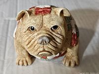 Front view of the Basher dog figurine showing the facial features and detailed fur texture.