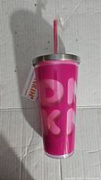 Front view of pink Dunkin Donuts tumbler showing logo and pink straw inside stainless steel lid