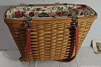 Side view of Longaberger Mother's Day Weekend basket showing woven wood wicker and floral fabric lining.