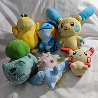 Photo showing all seven Pokémon plush toys grouped together for full lot view.