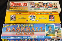 Photo showing the three boxed baseball card sets: 1991 Donruss, 1990 Score, and 1989 Topps, stacked together for sale.