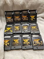 Twelve Magnavox Odyssey video game cartridges arranged in two rows, showing their front labels with game titles and box art.