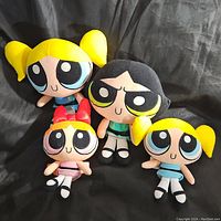 Four Powerpuff Girls plush toys on black background, showing two Bubbles, one Blossom and one Buttercup plushes.